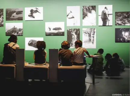 Groupe d'enfant de dos devant des photos